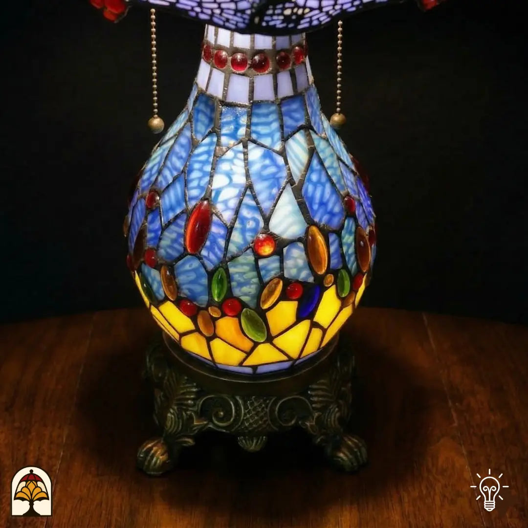 Onverlichte Tiffany tafellamp Libellula Azurea ⌀30 cm op zwarte achtergrond – azuurblauwe kap met libellenmotief, bronzen kolomvoet