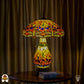 Tiffany lamp tafellamp verlicht op houten tafel met gordijn op de achtergrond, amberkleurige kap met libellemotieven en blauwe glaskralen, glas-in-lood peervormige voet en bronzen leeuwenpootvoet