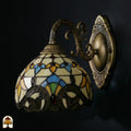 Onverlichte Tiffany wandlamp Barok van opzij met bronzen beugel, kap met barokke glas-in-lood stukken in goudgeel, blauw en rood