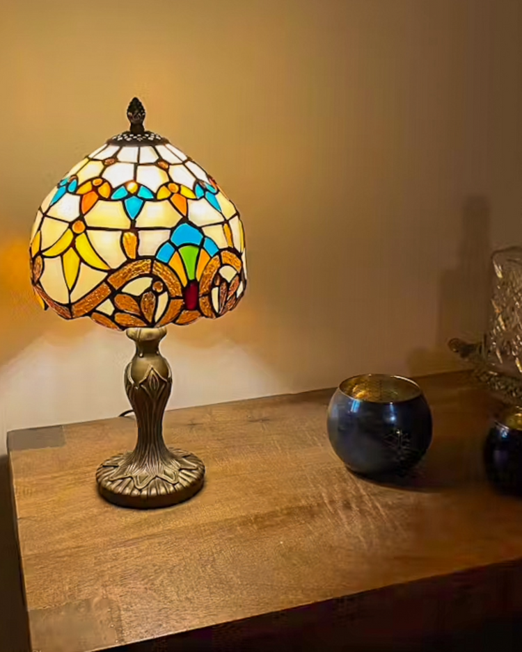 Tiffany tafellamp in barokstijl met rijk gedetailleerd glas-in-lood patroon, warm en sfeervol licht voor een klassiek interieur.